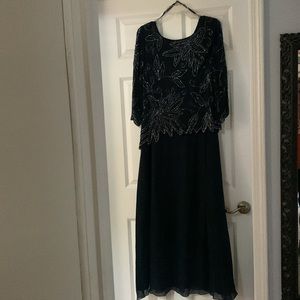 Beaded 3/4 sleeve. Sheer overlay, tea length skirt.